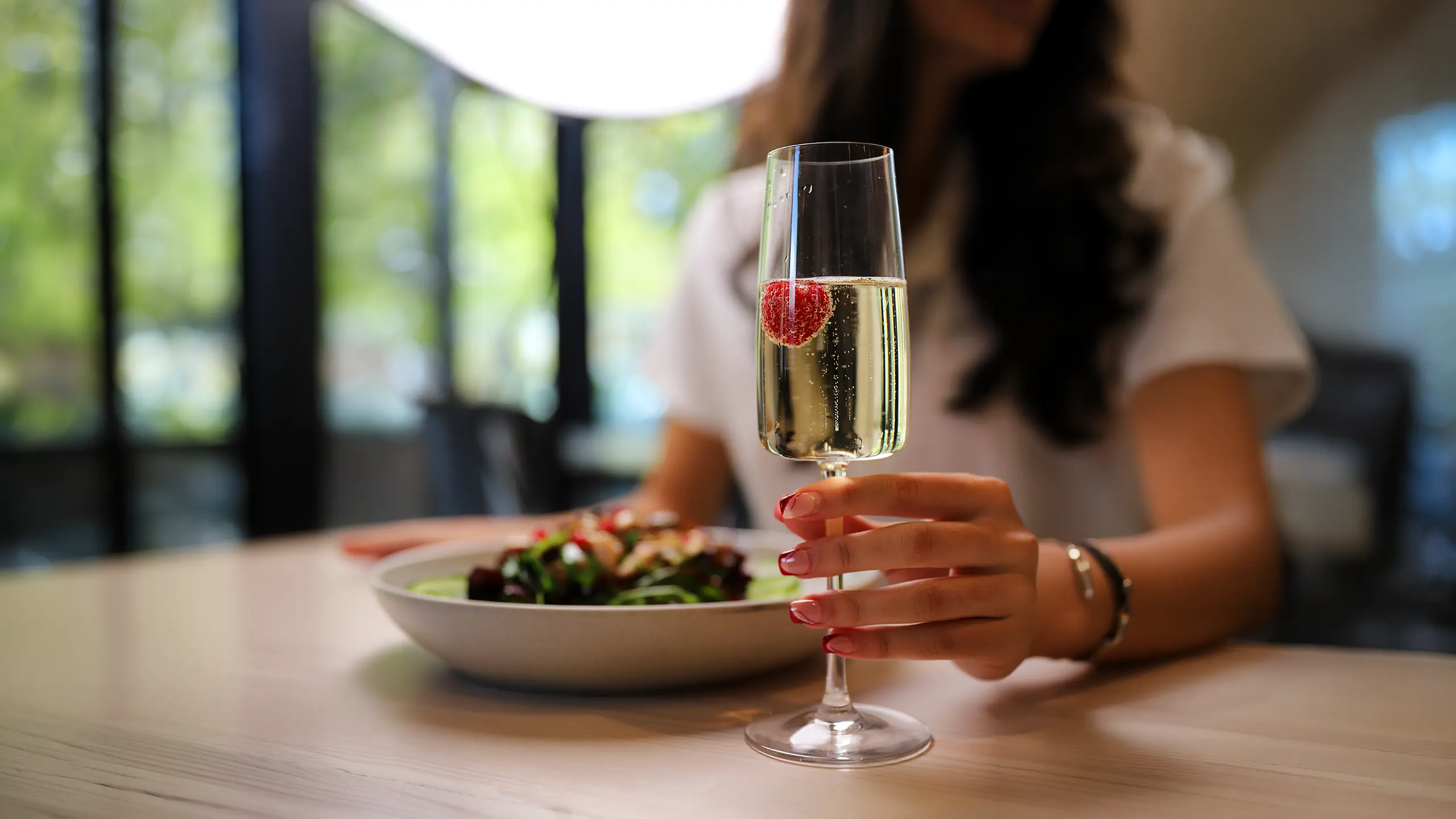 A glass of sparkling wine at the table